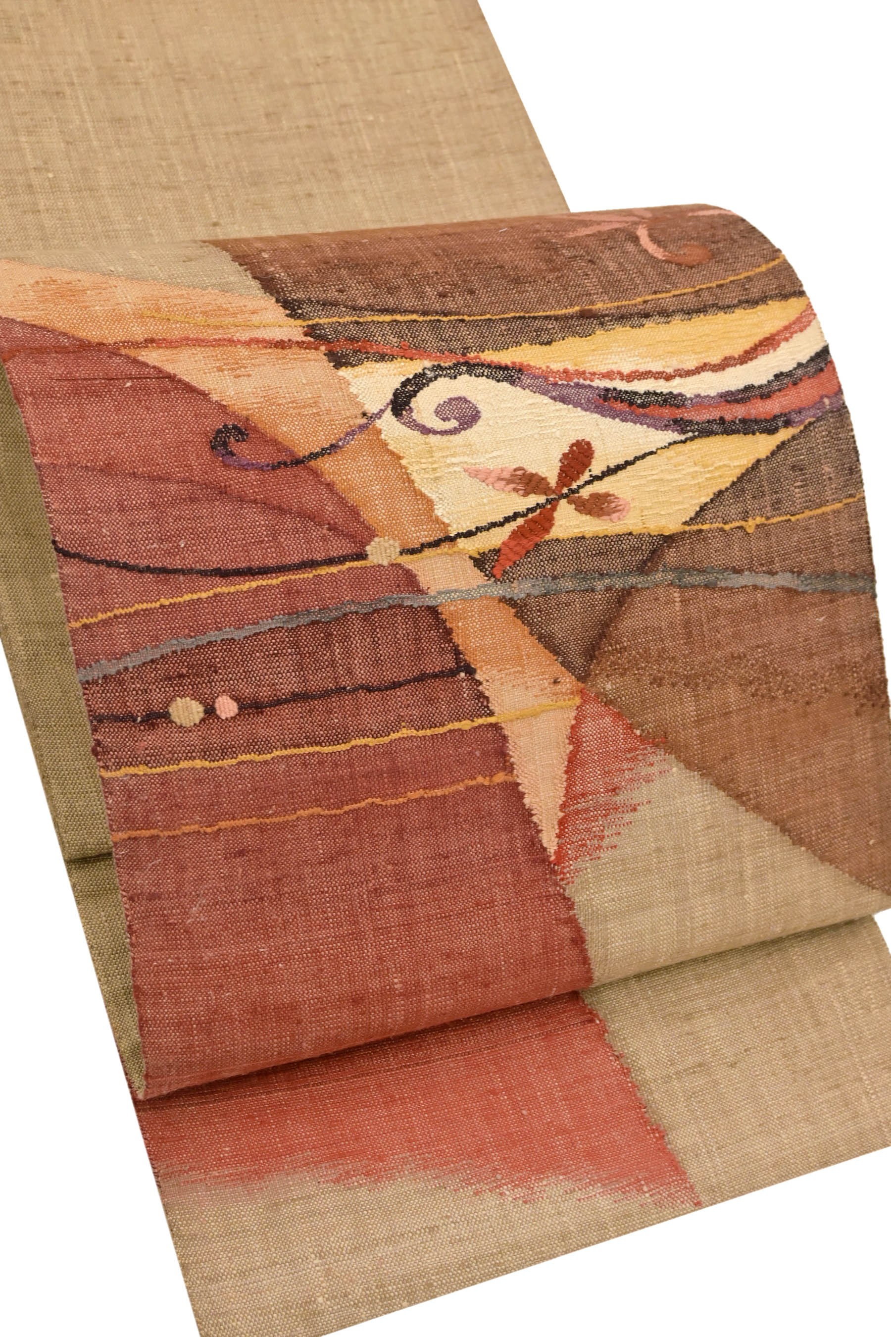 渡文　紬地の名古屋帯褐色紅梅色老竹色の抽象柄です